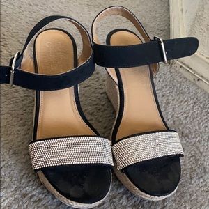 This is a black wedge with a silver blink top